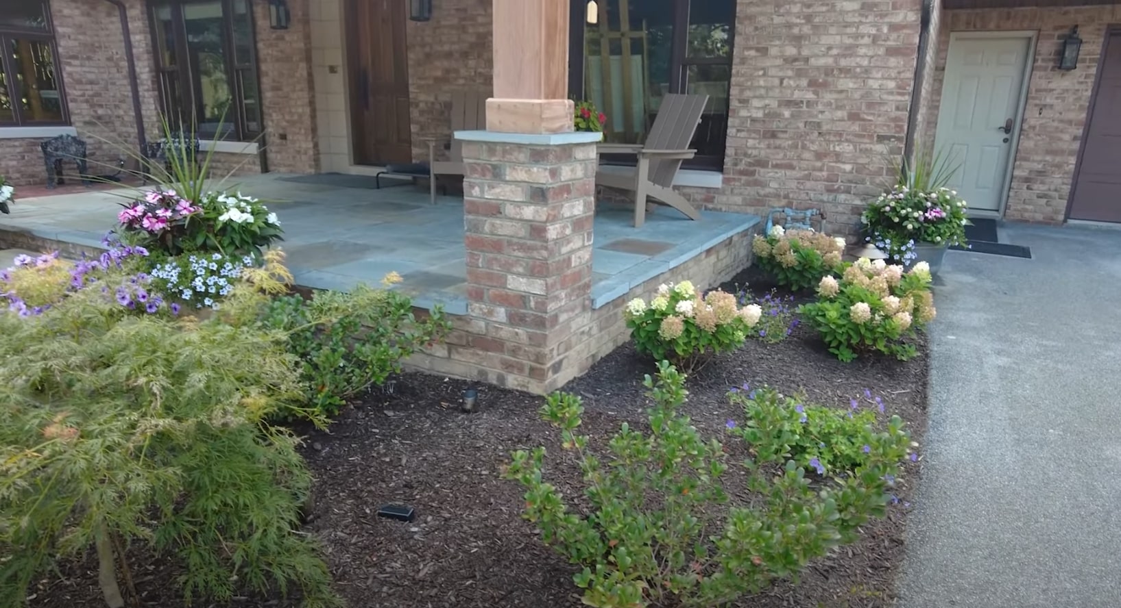 Modern home landscaping with professional flower bed design and seasonal plantings